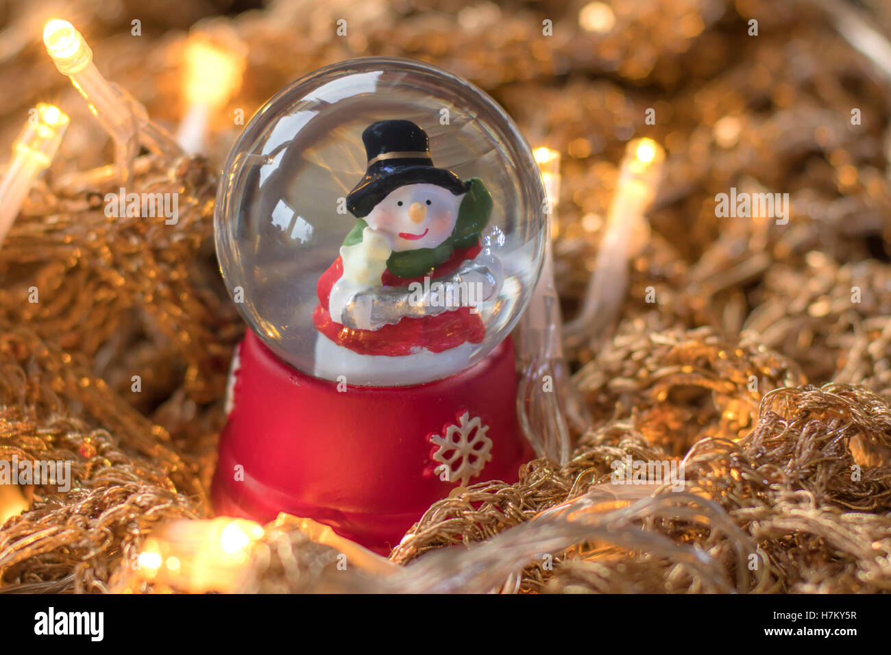 Snowman in snowglobe/snowball on golden, glittery runes with led lights ...