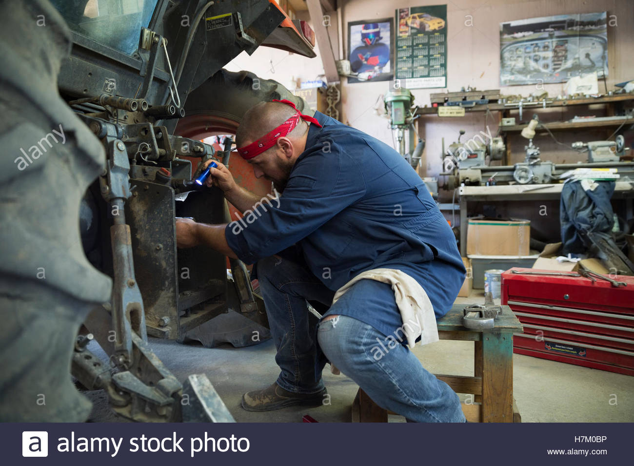 Mechanic working on tractor in Stock Photo Alamy