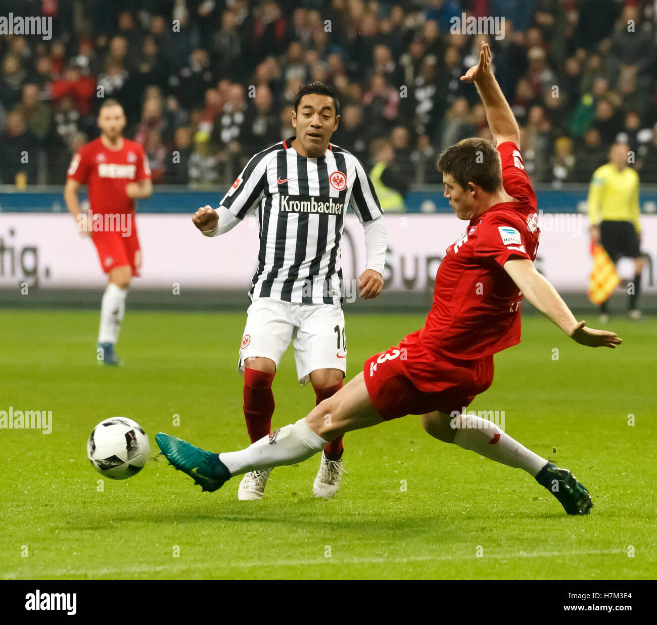 Frankfurt's Marco Fabian (l) and Cologne's Dominique Heintz in action during the Bundesliga soccer match between Eintracht Frankfurt and 1. FC Cologne at the Commerzbank-Arena in Frankfurt/Main, Germany, 5 November 2016. PHOTO: RONALD WITTEK/dpa Stock Photo