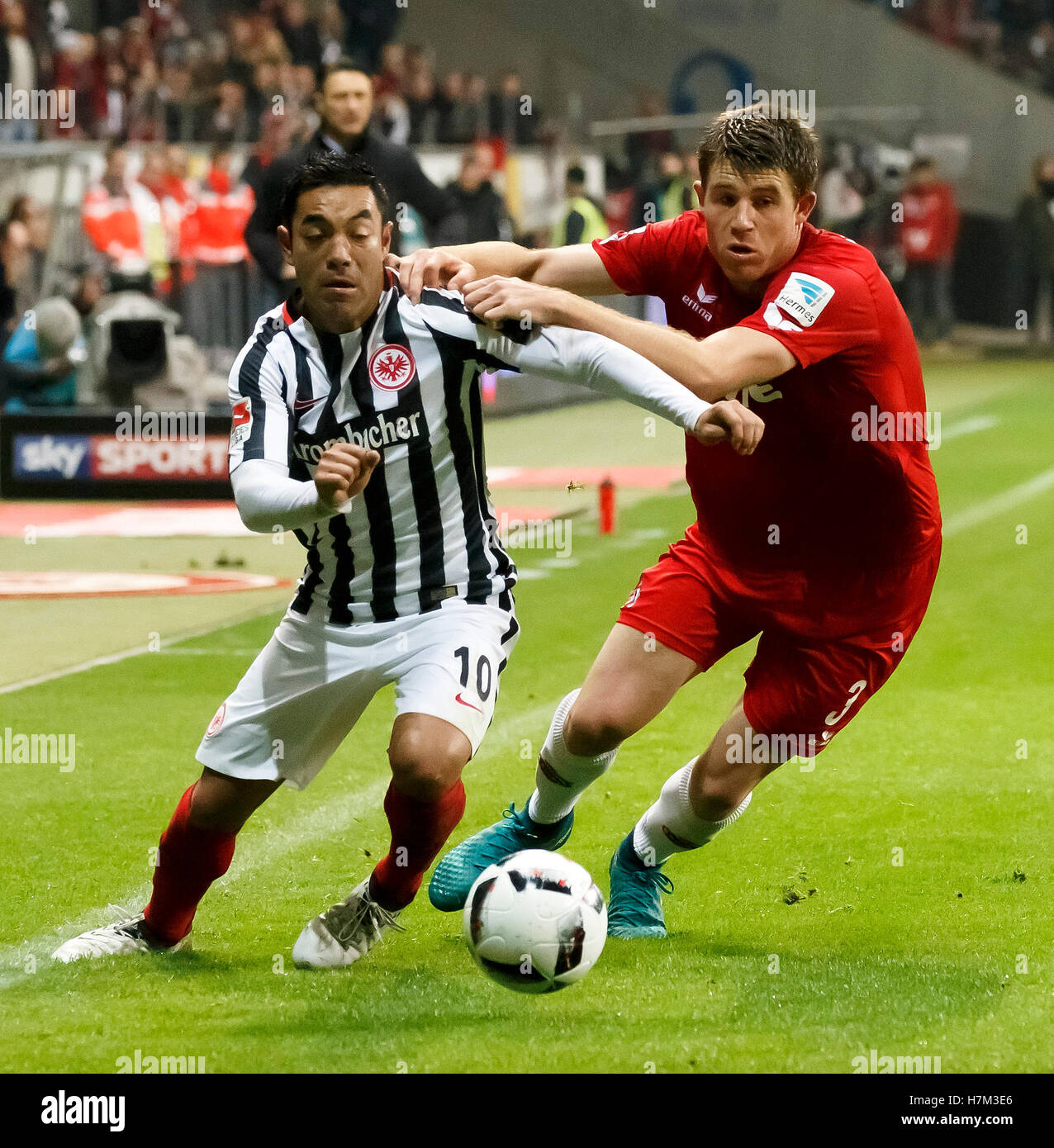 Frankfurt's Marco Fabian (l) and Cologne's Dominique Heintz in action during the Bundesliga soccer match between Eintracht Frankfurt and 1. FC Cologne at the Commerzbank-Arena in Frankfurt/Main, Germany, 5 November 2016. PHOTO: RONALD WITTEK/dpa Stock Photo