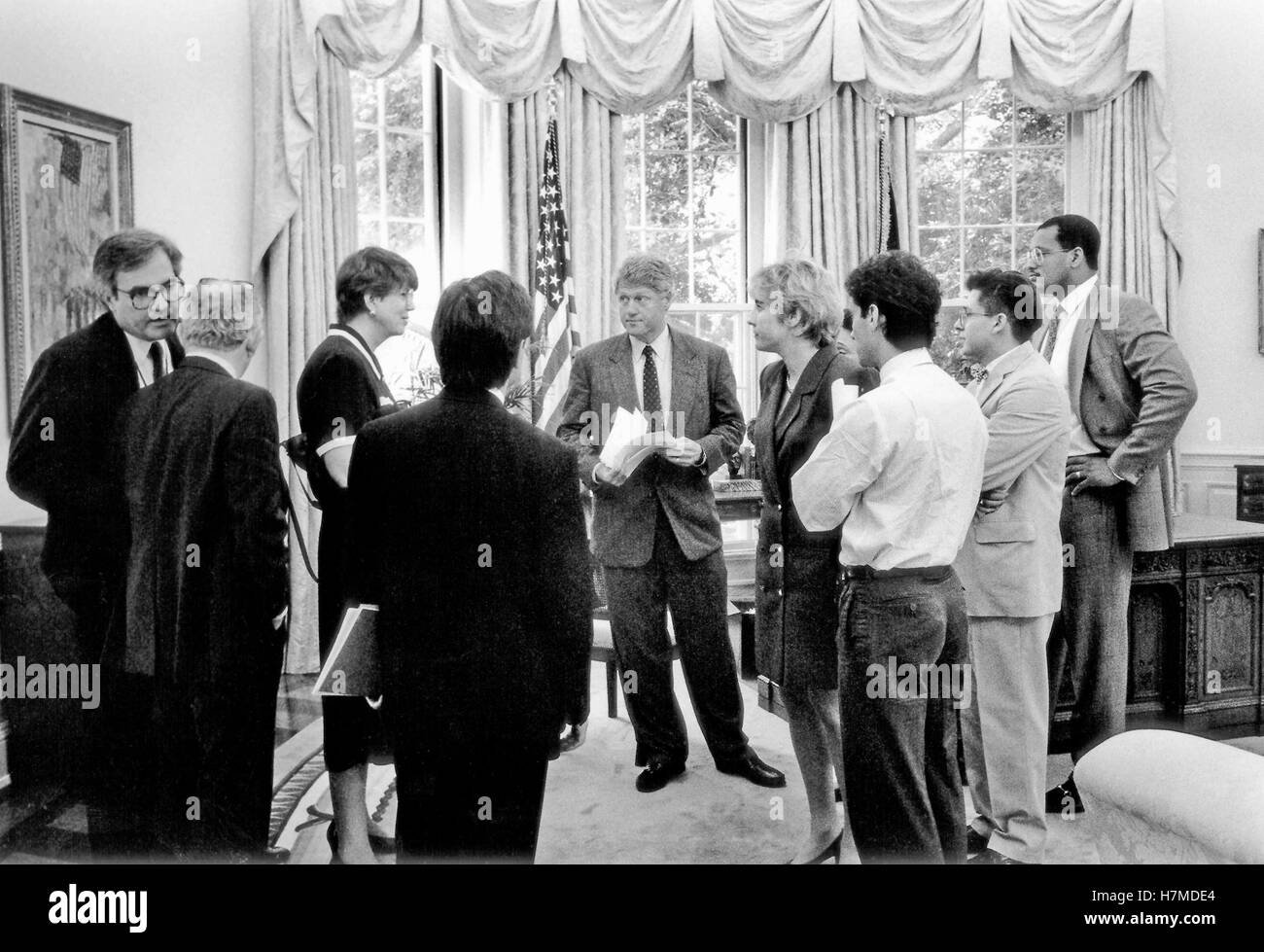 United States President Bill Clinton meets with Attorney General Janet Reno in the Oval Office of the White House in Washington, DC on Thursday, June 24, 1993. White House Counsel Vince Foster, far left, is whispering into the ear of fellow counsel Bernard Nussbaum. Press Secretary Dee Dee Myers is at the immediate right of The President.Credit: White House via CNP /MediaPunch Stock Photo