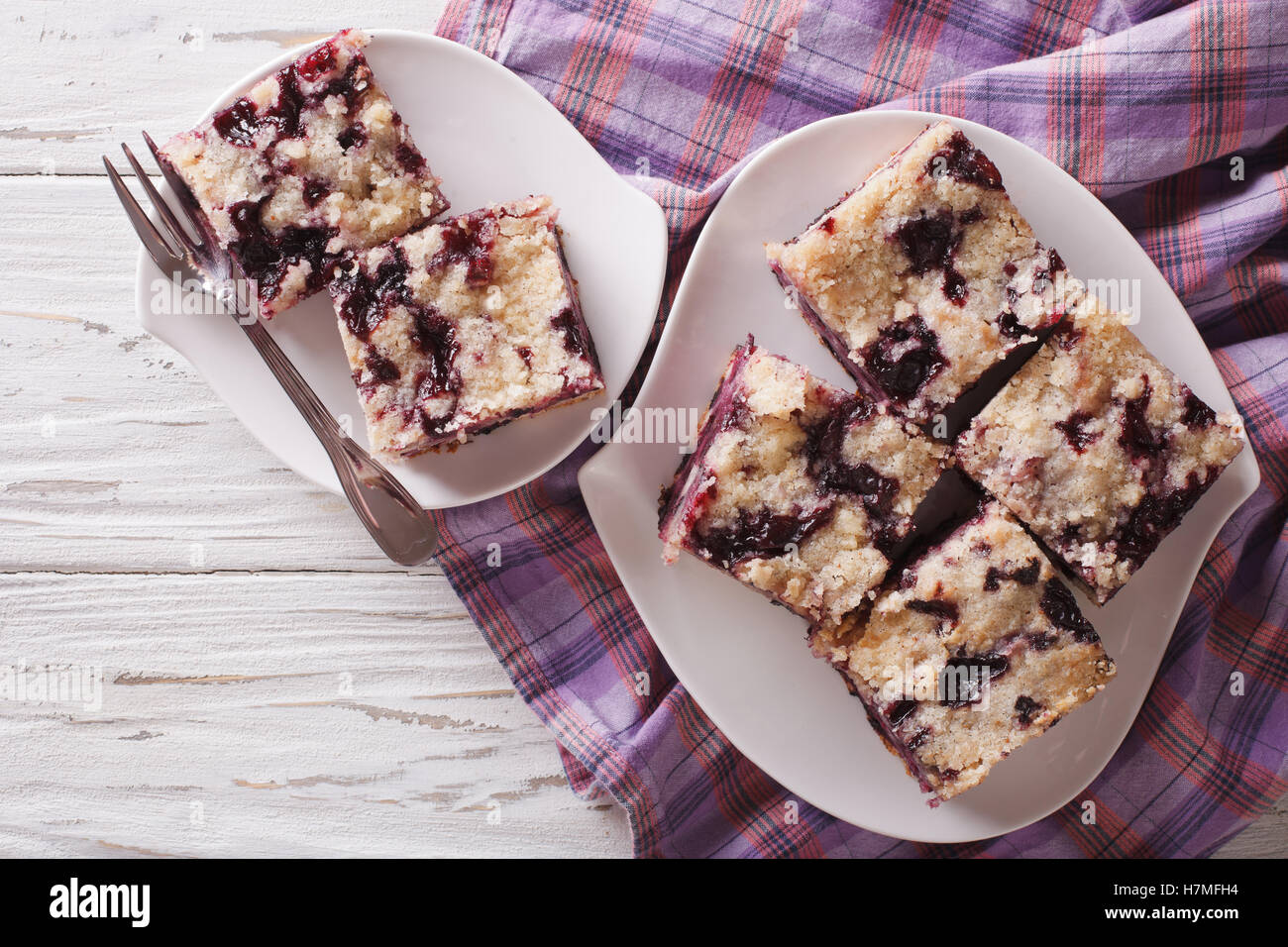 Sponge cake with blueberries close-up on a plate on the table. horizontal view from above Stock Photo