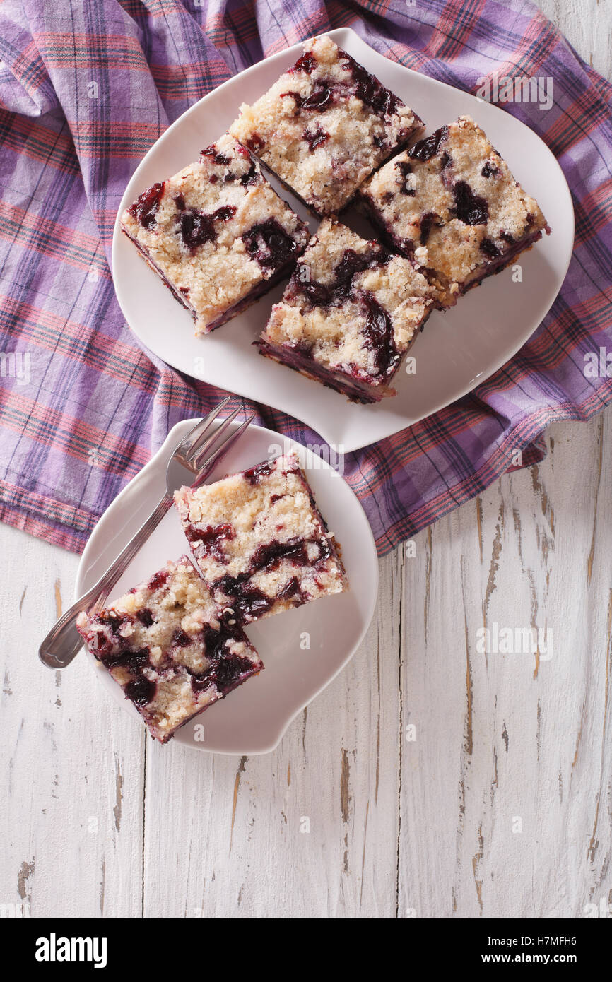 Sponge cake with blueberries close-up on a plate on the table. Vertical view from above Stock Photo
