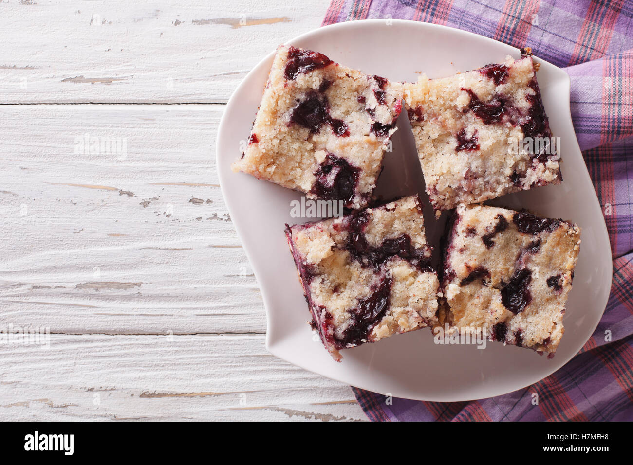 Berry pie with blueberries close-up on a plate on the table. horizontal view from above Stock Photo