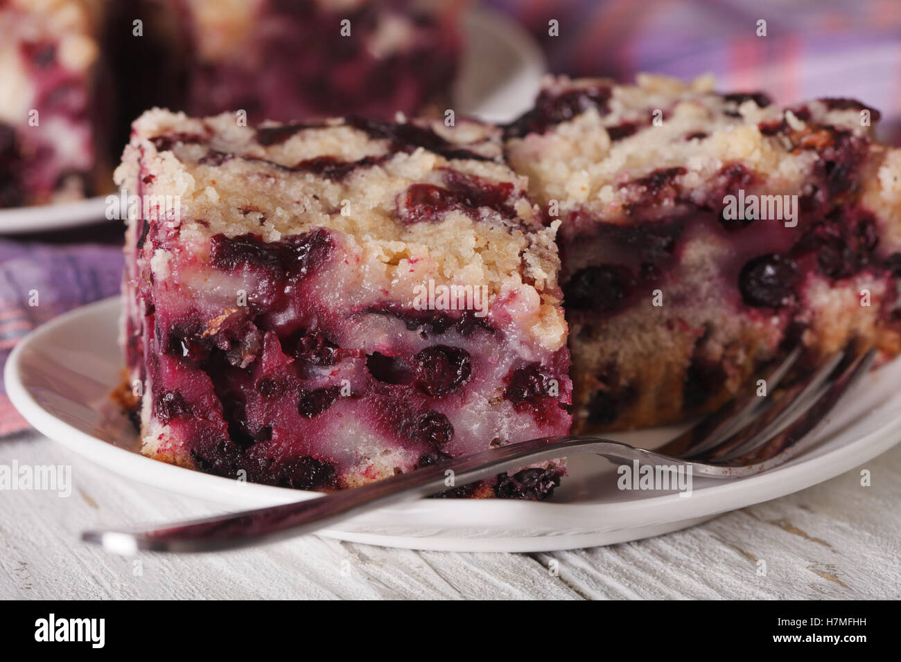 Cut macro blueberry pie on a plate on the table. horizontal Stock Photo