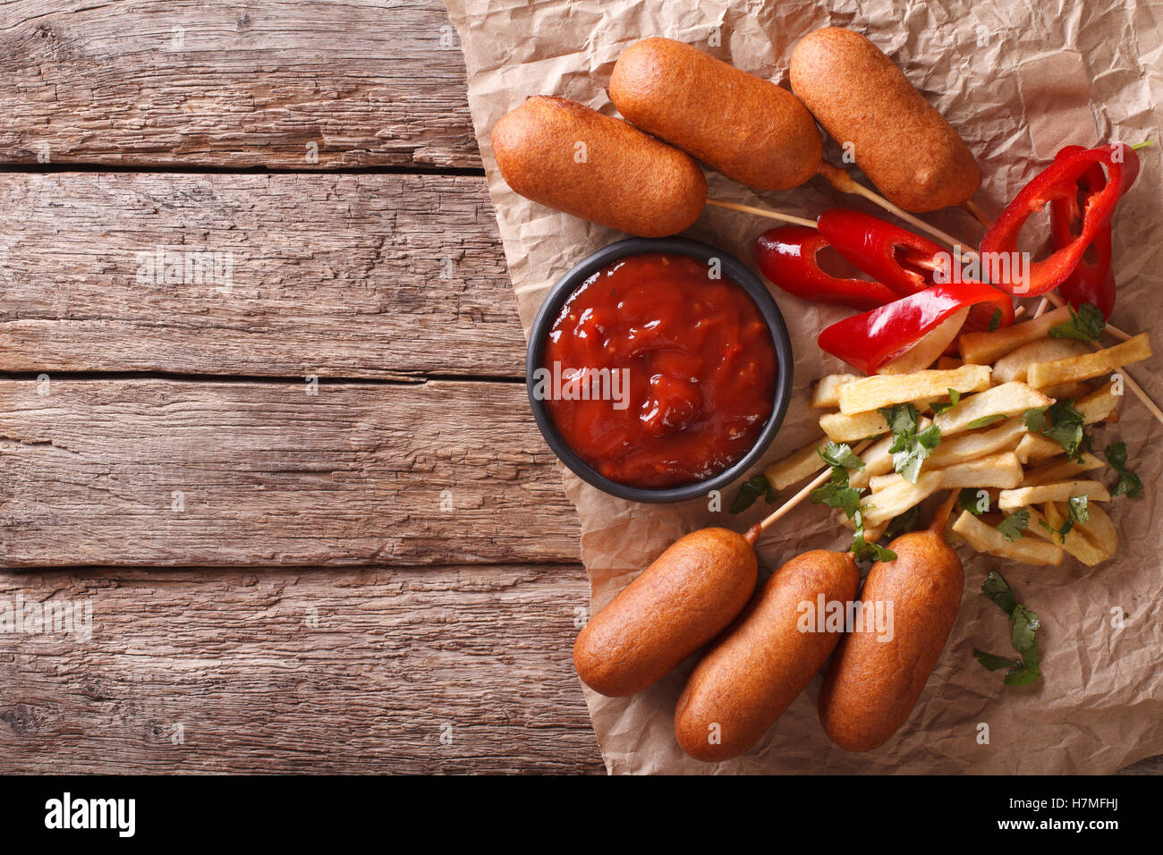 Fast Food: Corn dogs, french fries and ketchup on the table. horizontal view from above Stock Photo