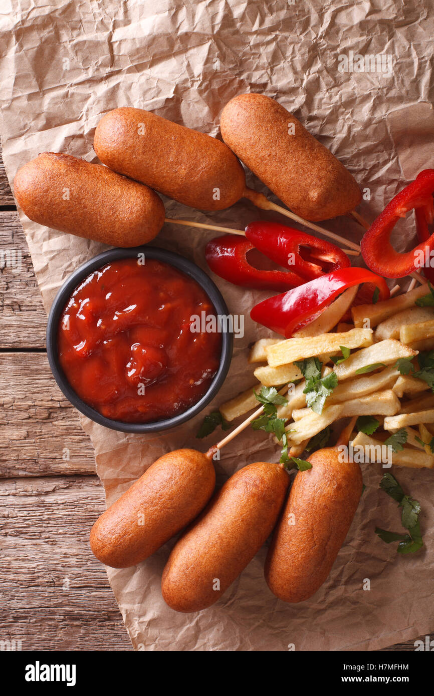 Fast Food: Corn dogs, french fries and ketchup close-up on the table. vertical view from above Stock Photo