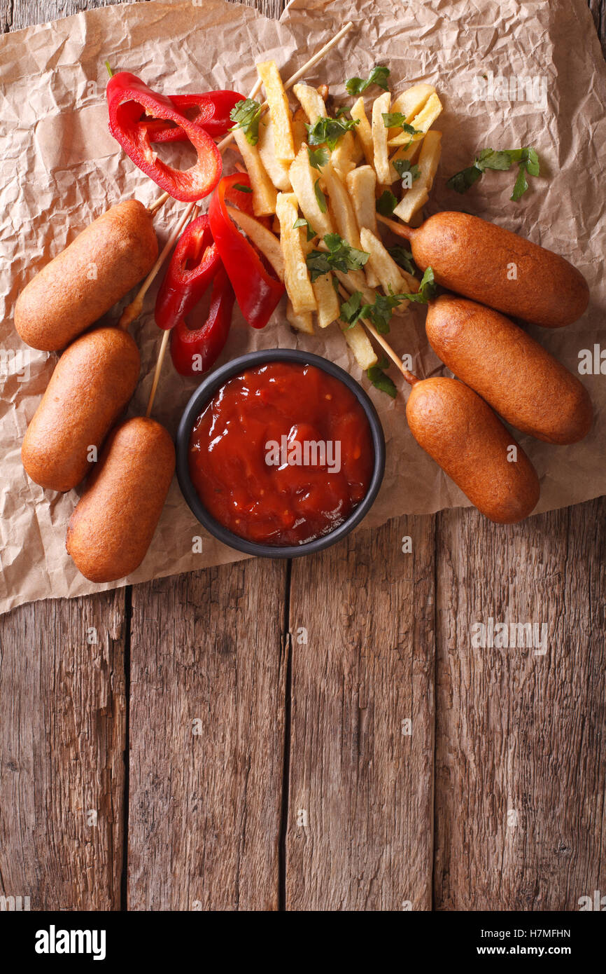Fast Food: Corn dogs, french fries and ketchup on the table. vertical view from above Stock Photo