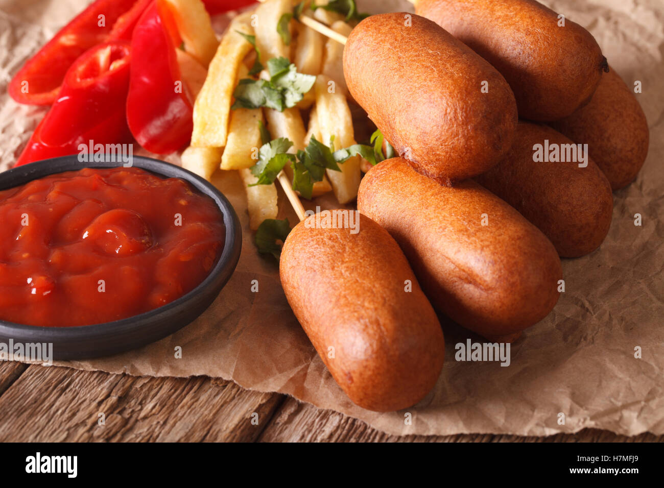 American fast food: Corn dogs, french fries and ketchup on the table close-up. horizontal Stock Photo