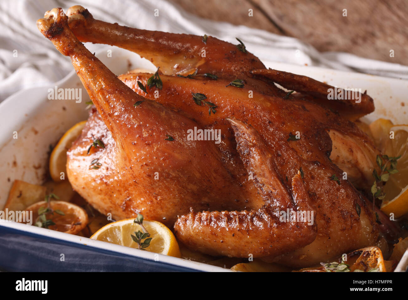 Chicken with lemon and thyme baked in a baking dish closeup. horizontal Stock Photo