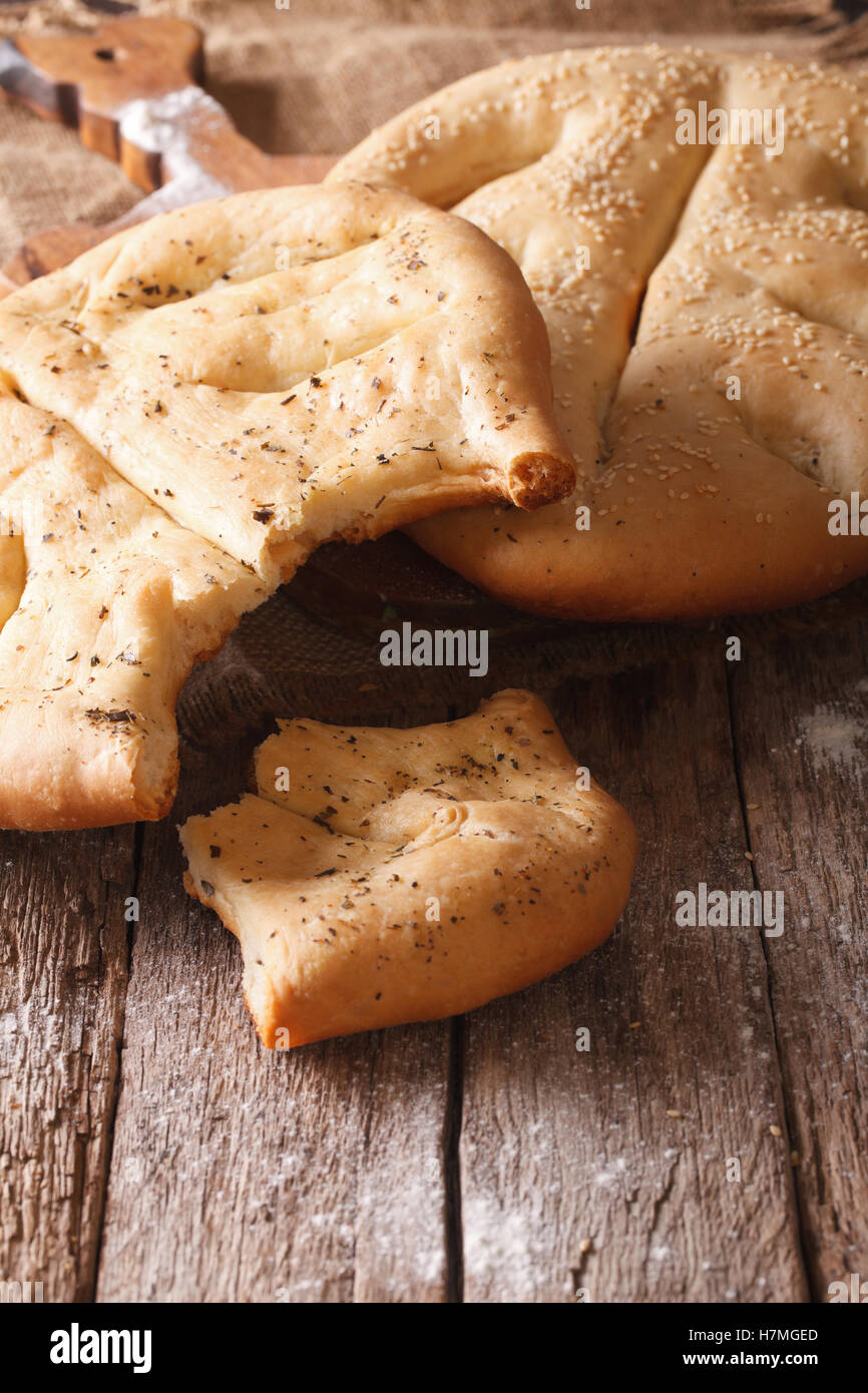 Fougasse French bread with sesame seeds and herbs closeup on the table. vertical Stock Photo