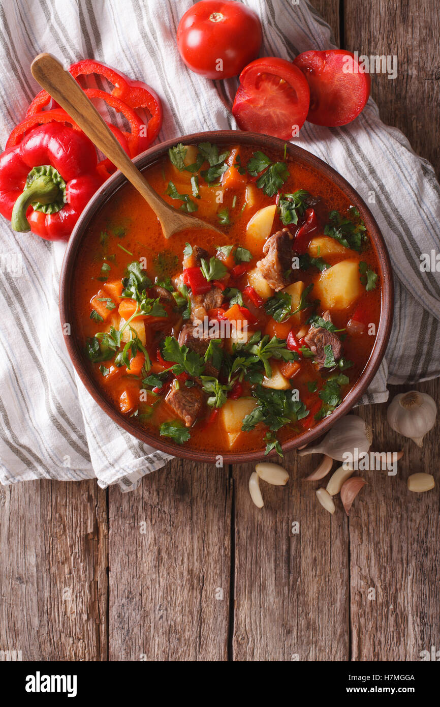 Tasty Hungarian goulash soup bograch close-up on the table and ingredients. Vertical view from above Stock Photo