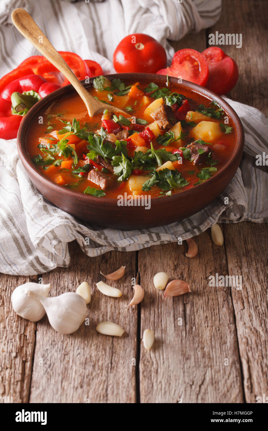 Tasty Hungarian goulash soup bograch close-up on the table and ingredients. vertical Stock Photo