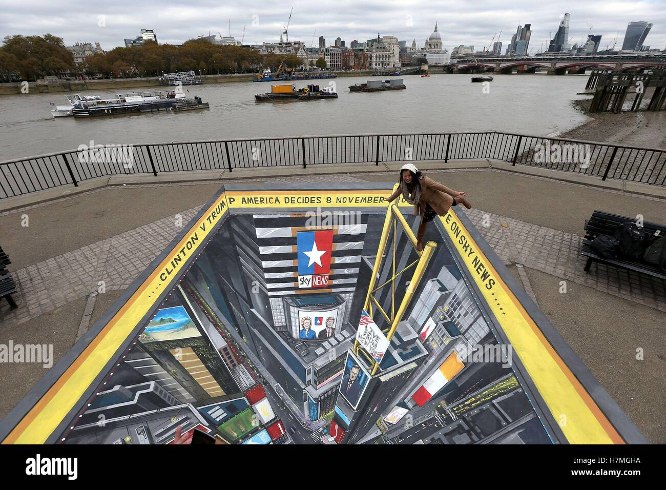 A woman balances on the edge of a 3D visualisation of Times Square, New York, created by street artist Joe Hill at Observation Point on London's South Bank. Stock Photo