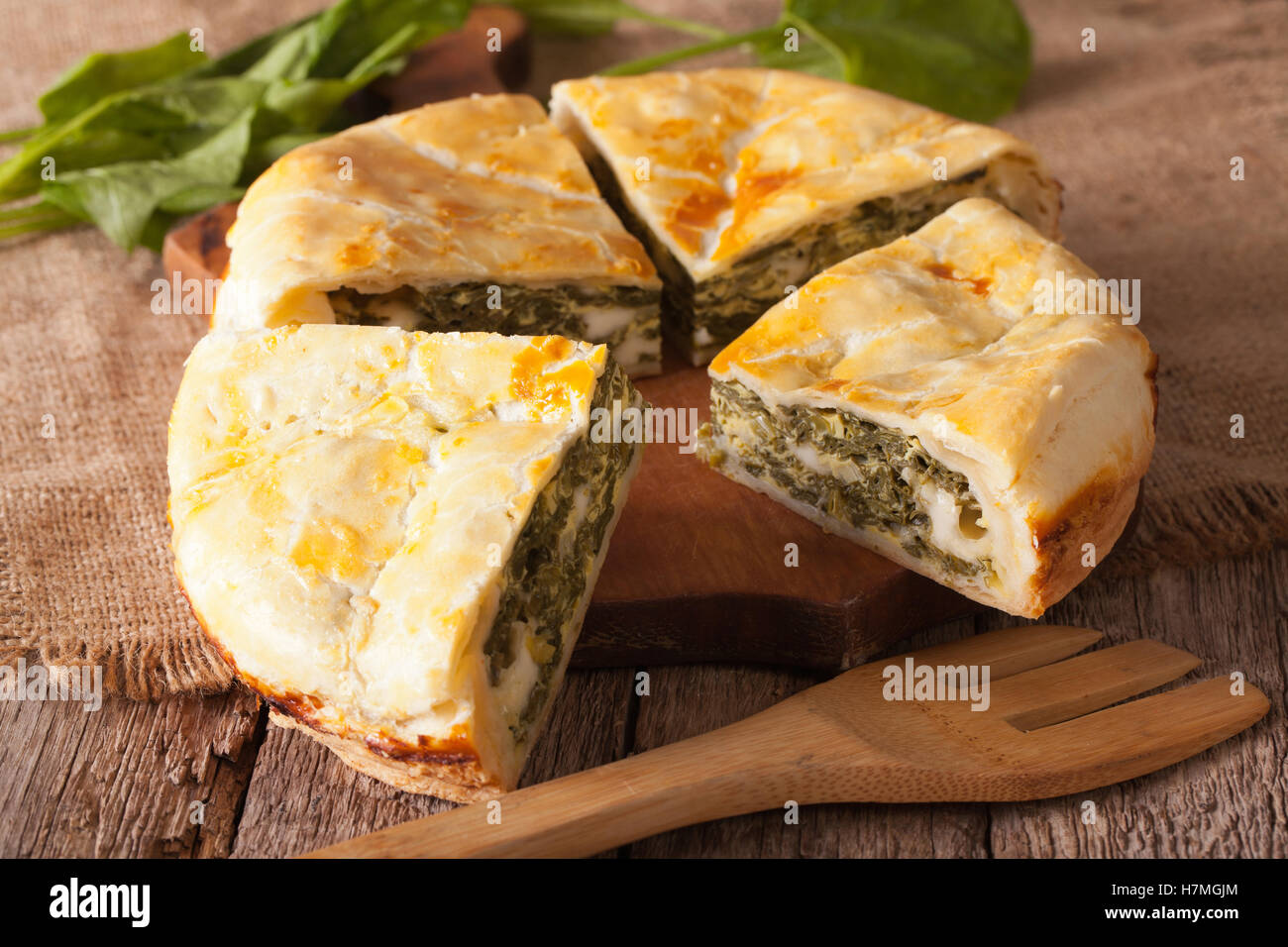 Tasty sliced Greek spanakopita pie close-up on the table. horizontal Stock Photo