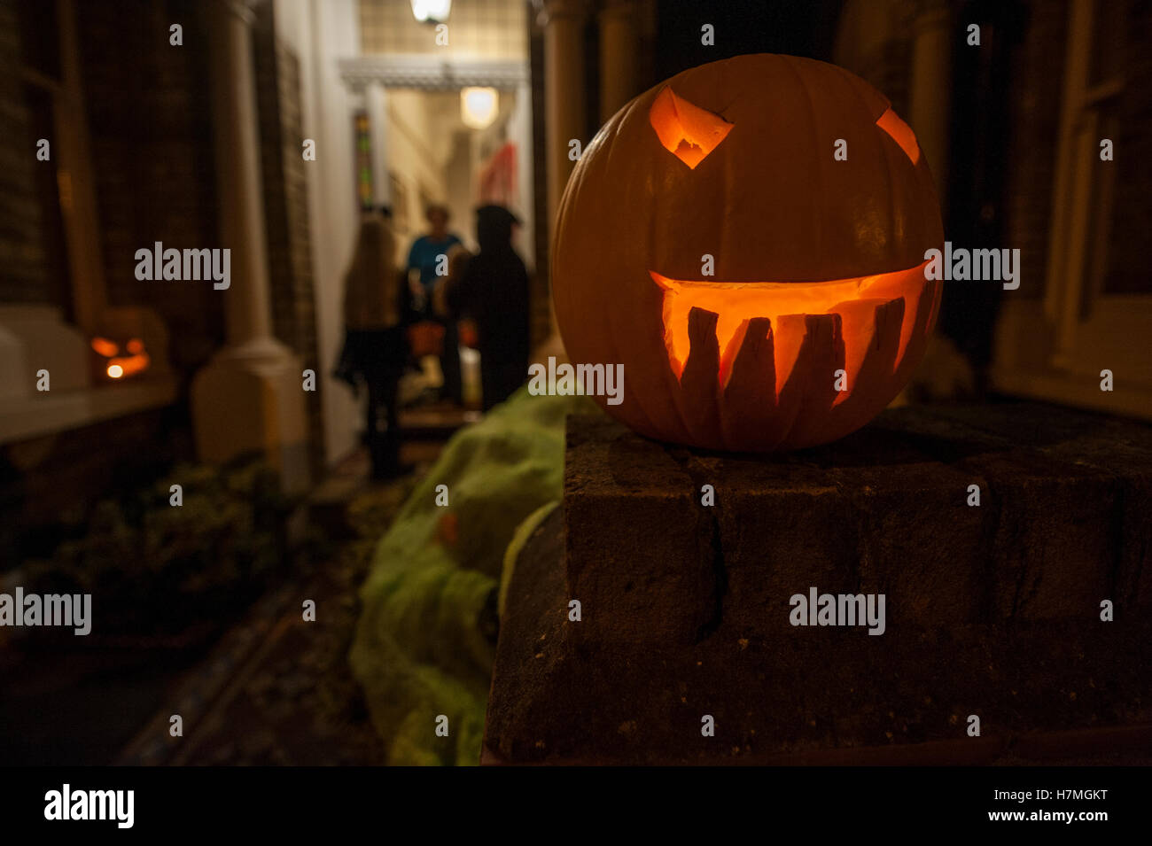 Trick or treaters knocking on a door in a London residential house ...