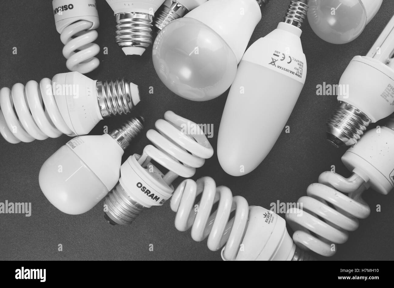 mixed low power fluorescent light bulbs on a dark surface - energy saving Stock Photo