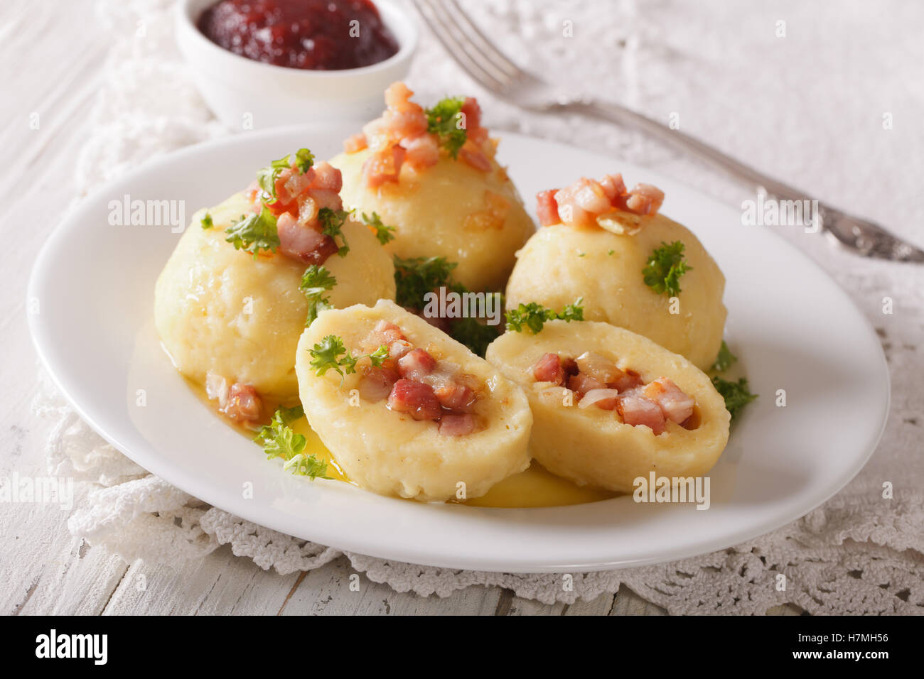 potato dumplings with bacon, butter and parsley close-up on a plate. horizontal Stock Photo