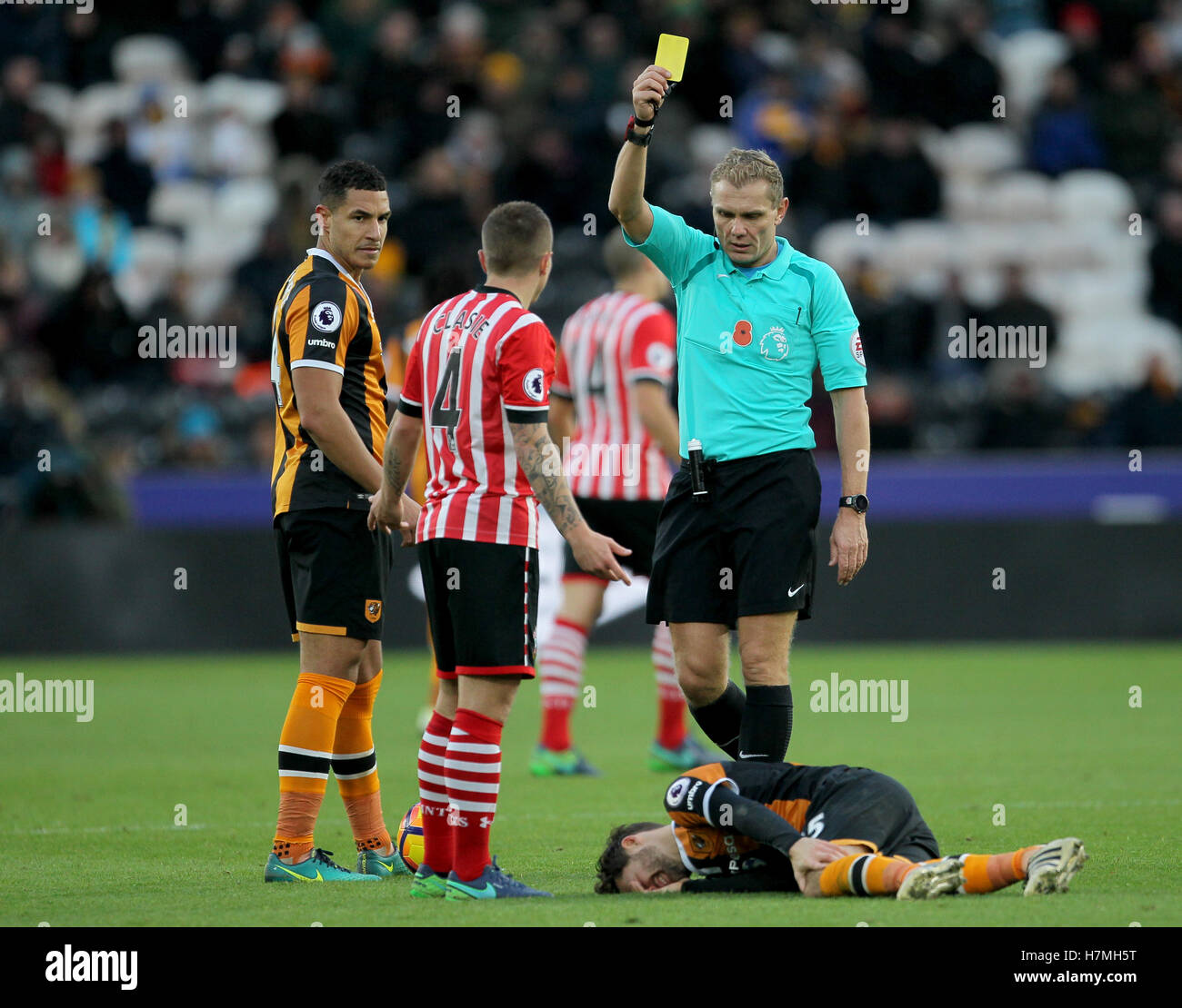 Southampton's Jordy Clasie (centre) is shown the yellow card during the Premier League match at the KCOM Stadium, Hull. Stock Photo