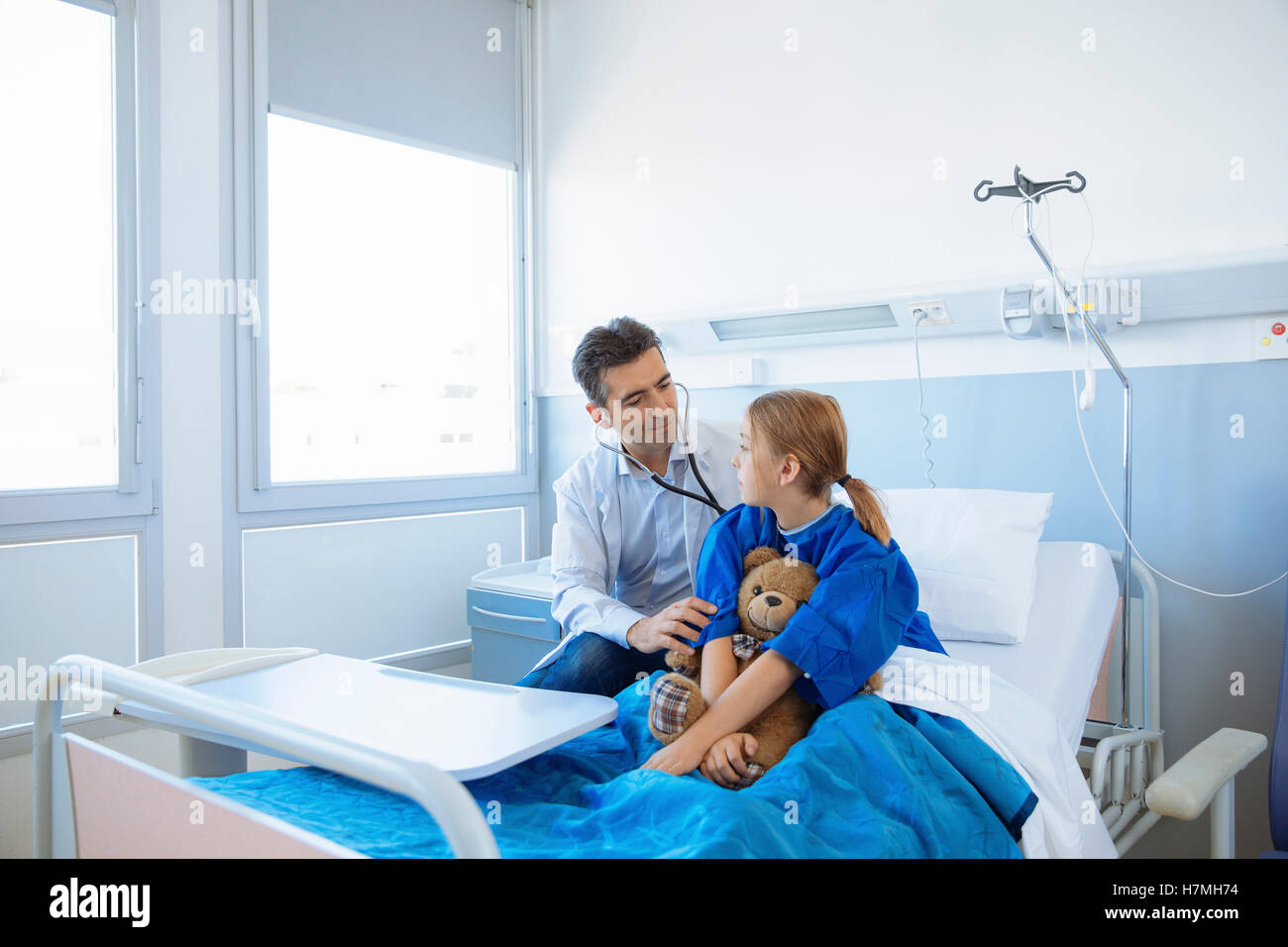 Doctor examining girl patient in hospital Stock Photo