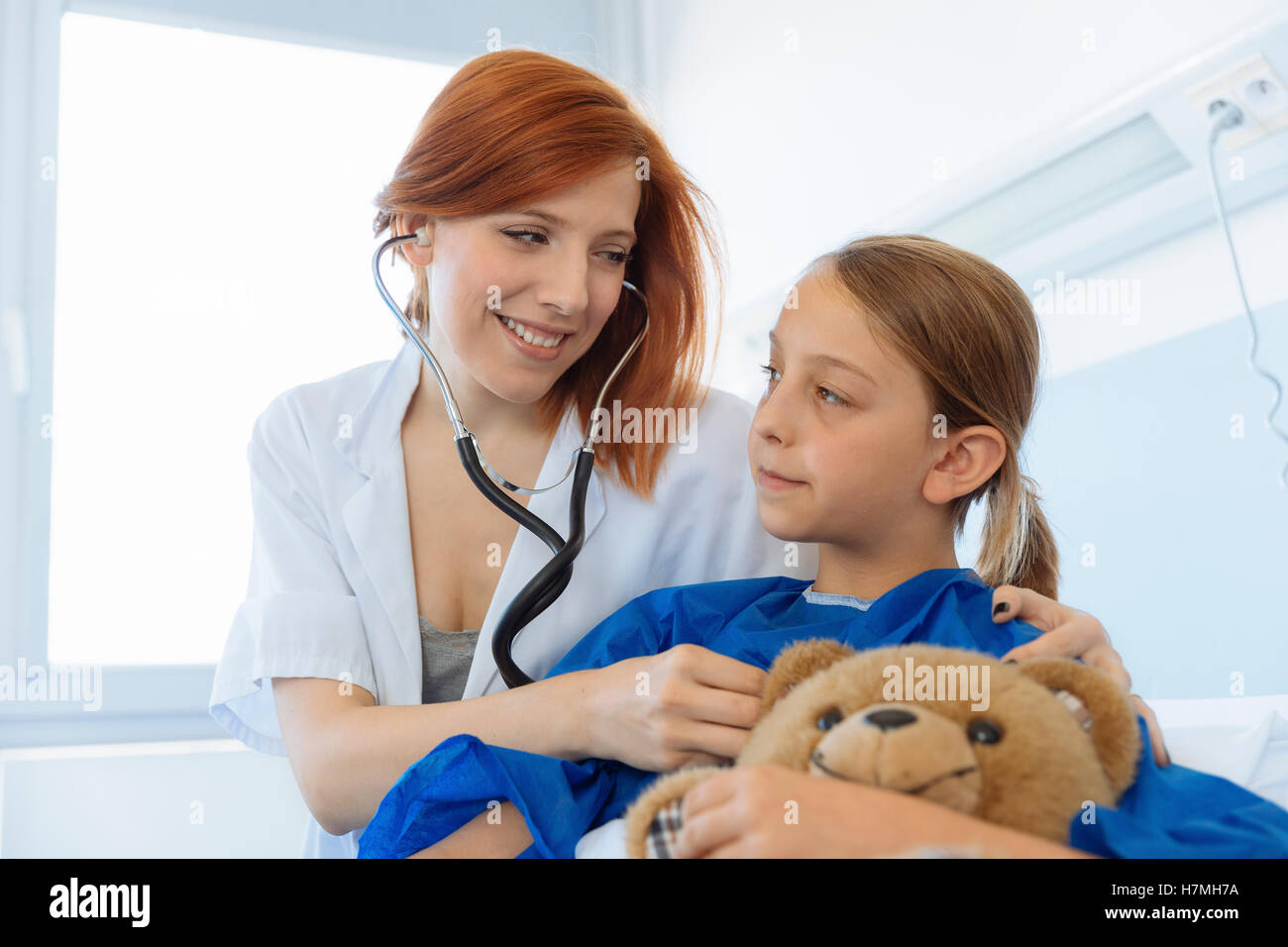 Doctor examining a young girl in hospital Stock Photo