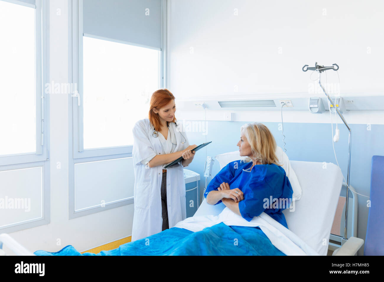Doctor examining a senior patient in hospital Stock Photo