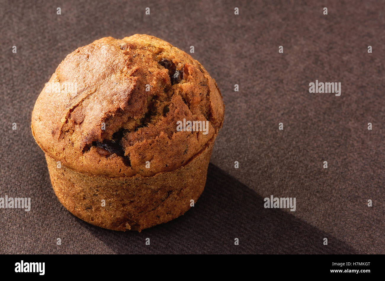 Fresh home made muffin on brown background Stock Photo