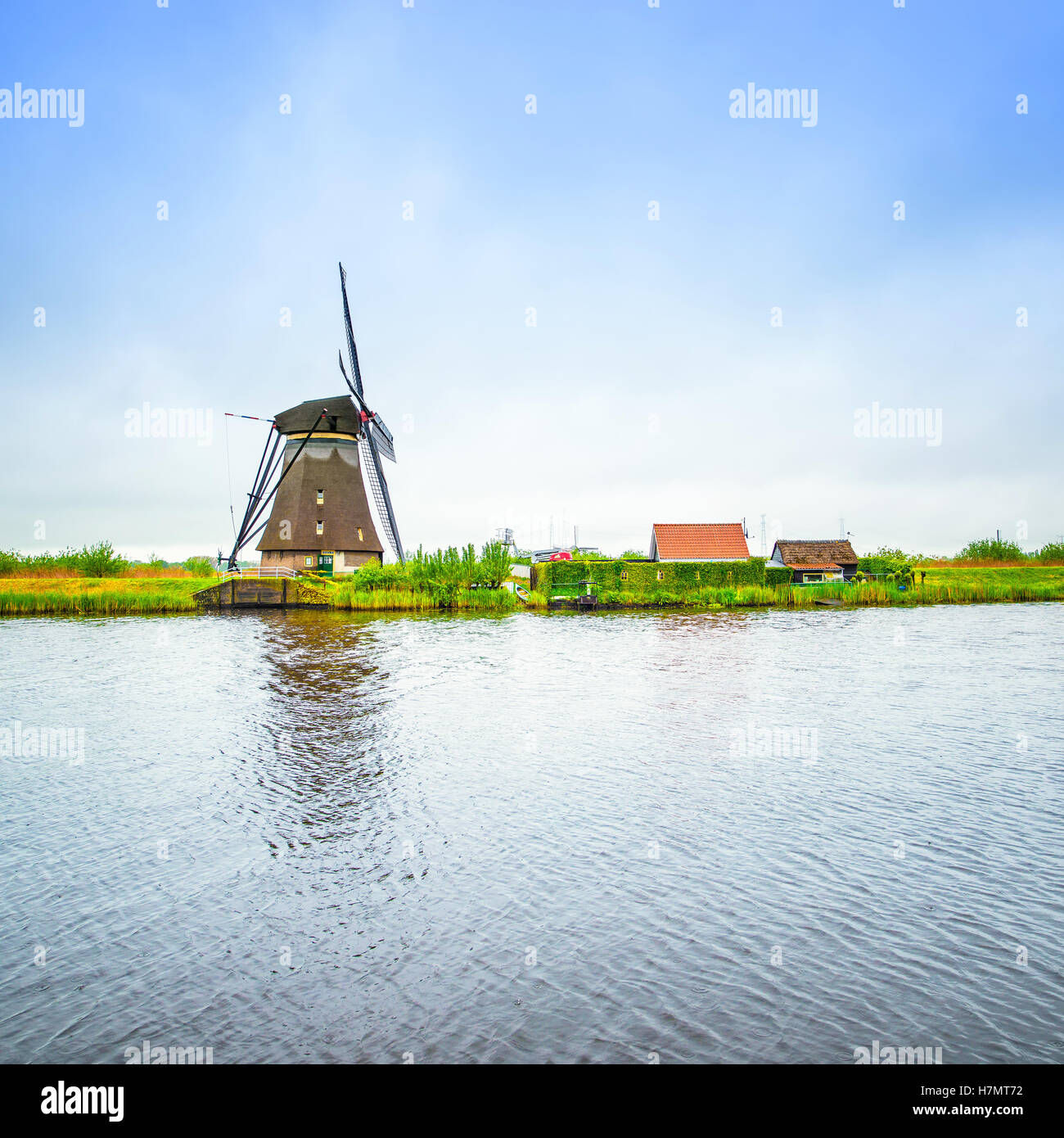 Windmill and water canal reflection in Kinderdijk, Holland or Netherlands. Unesco world heritage site. Europe. Stock Photo