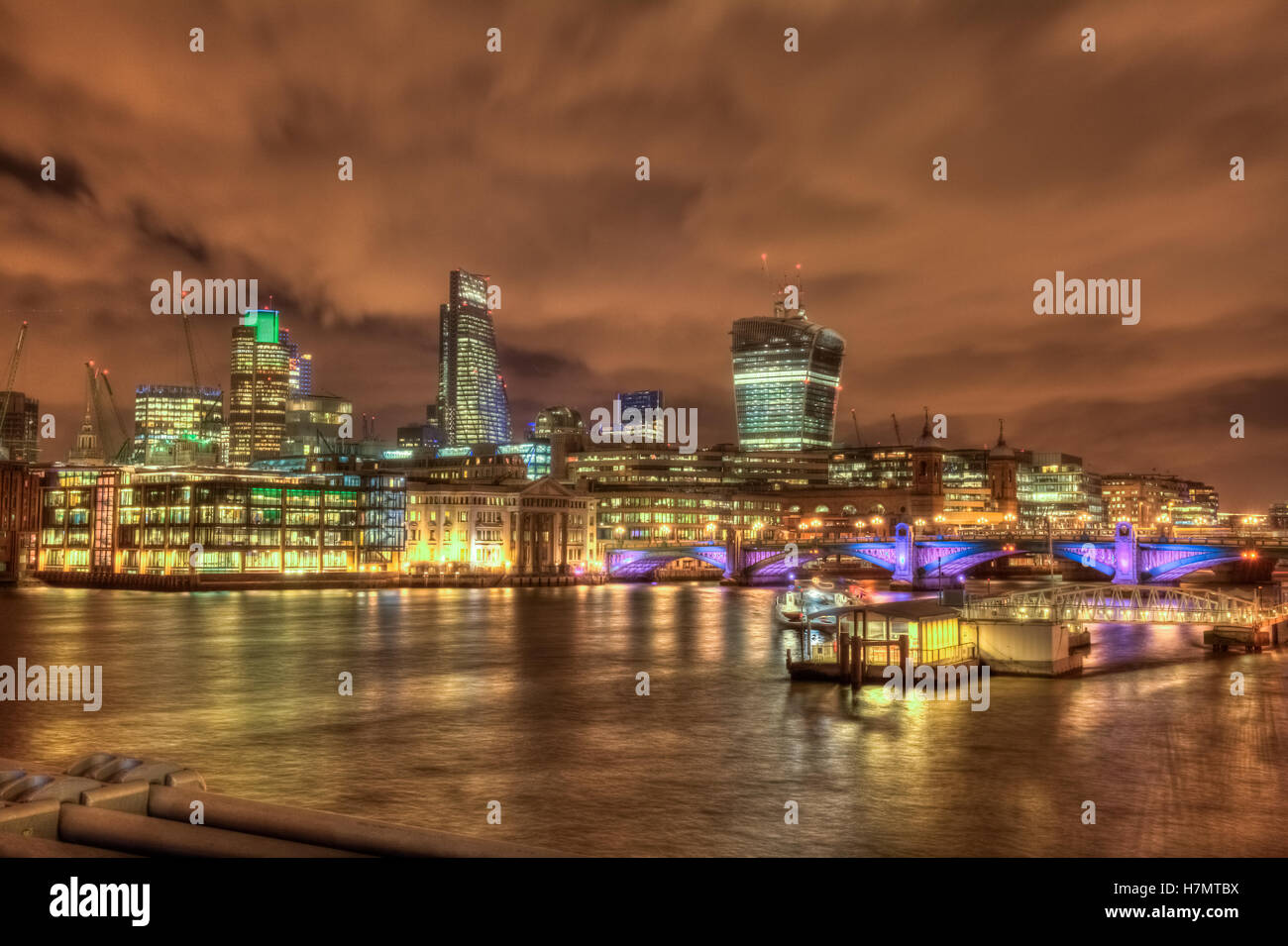 Night skyline of London as seen from the Thames riverbank, England ...