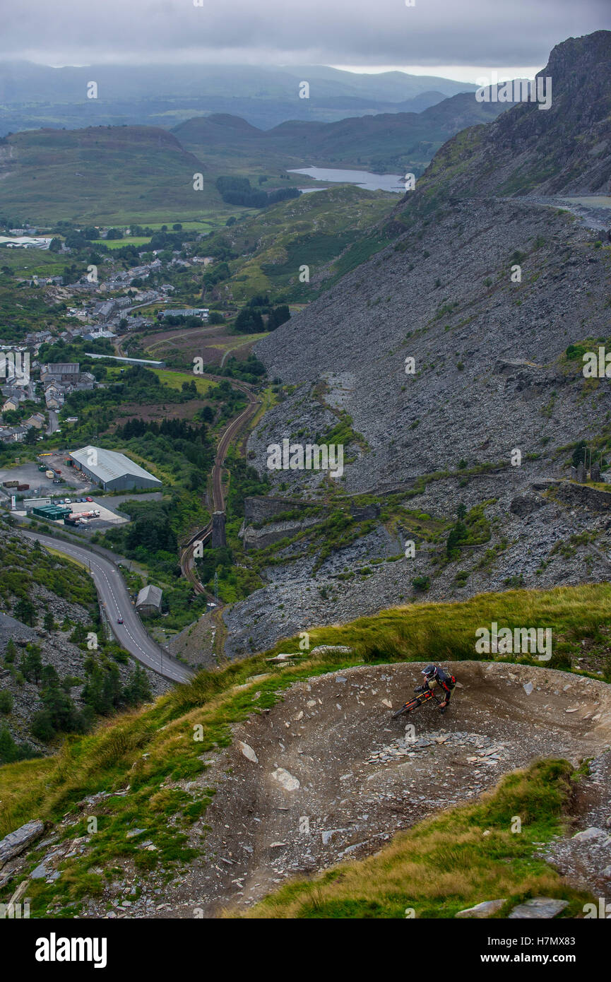 A mountain biker skids round a corner at Antur Stiniog mountain bike