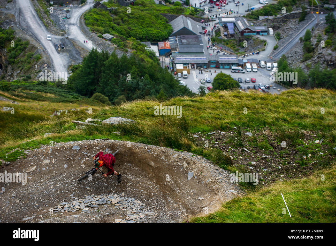A mountain biker skids round a corner at Antur Stiniog mountain bike