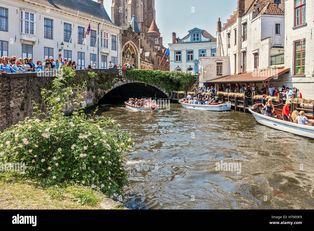 People Watching The Boats Go By Bruges Belgium Stock Photo