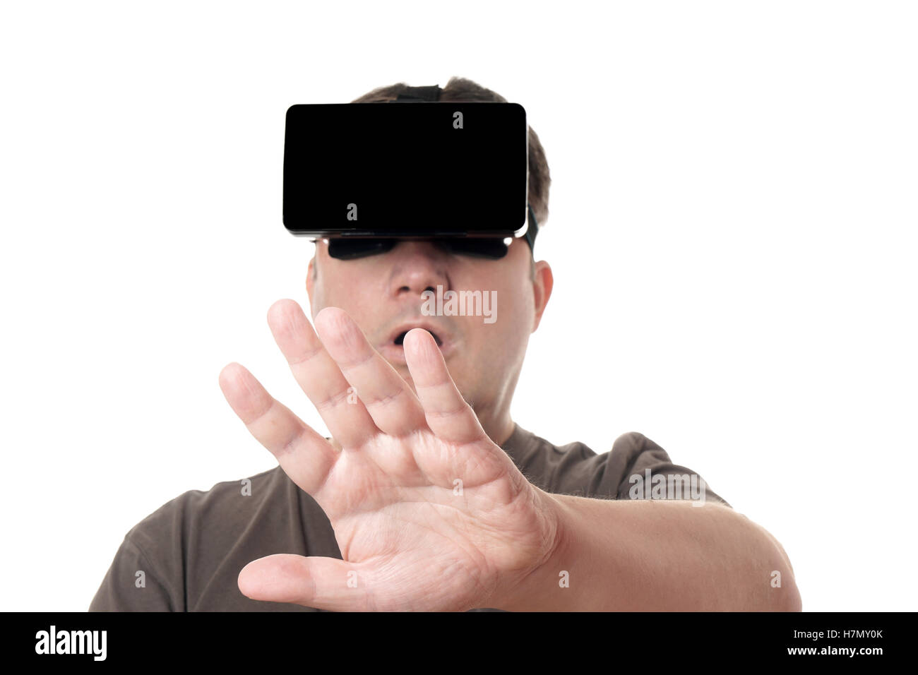 man wearing VR virtual reality headset reaching out Stock Photo