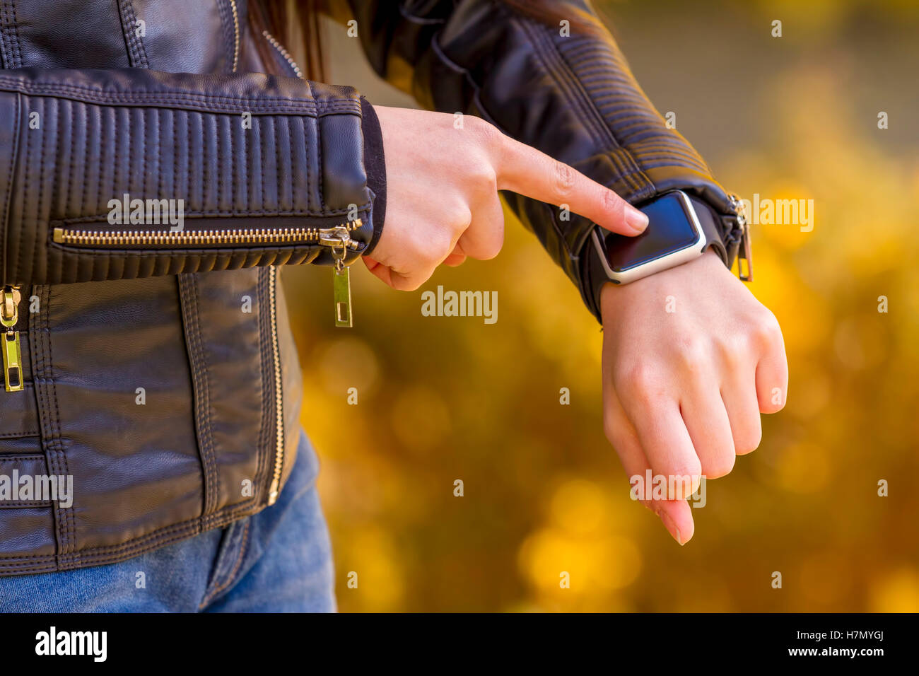 Young girl wears smart watch with touchscreen. Focus on hand! Stock Photo