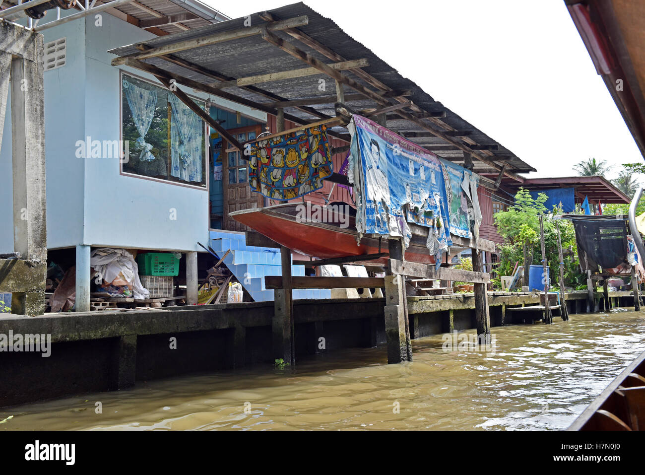 Canoe outside stilt dwellings at the Damnoen Saduak Floating Market