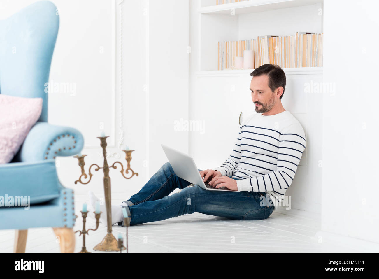 Handsome joyful man looking at the laptop screen Stock Photo