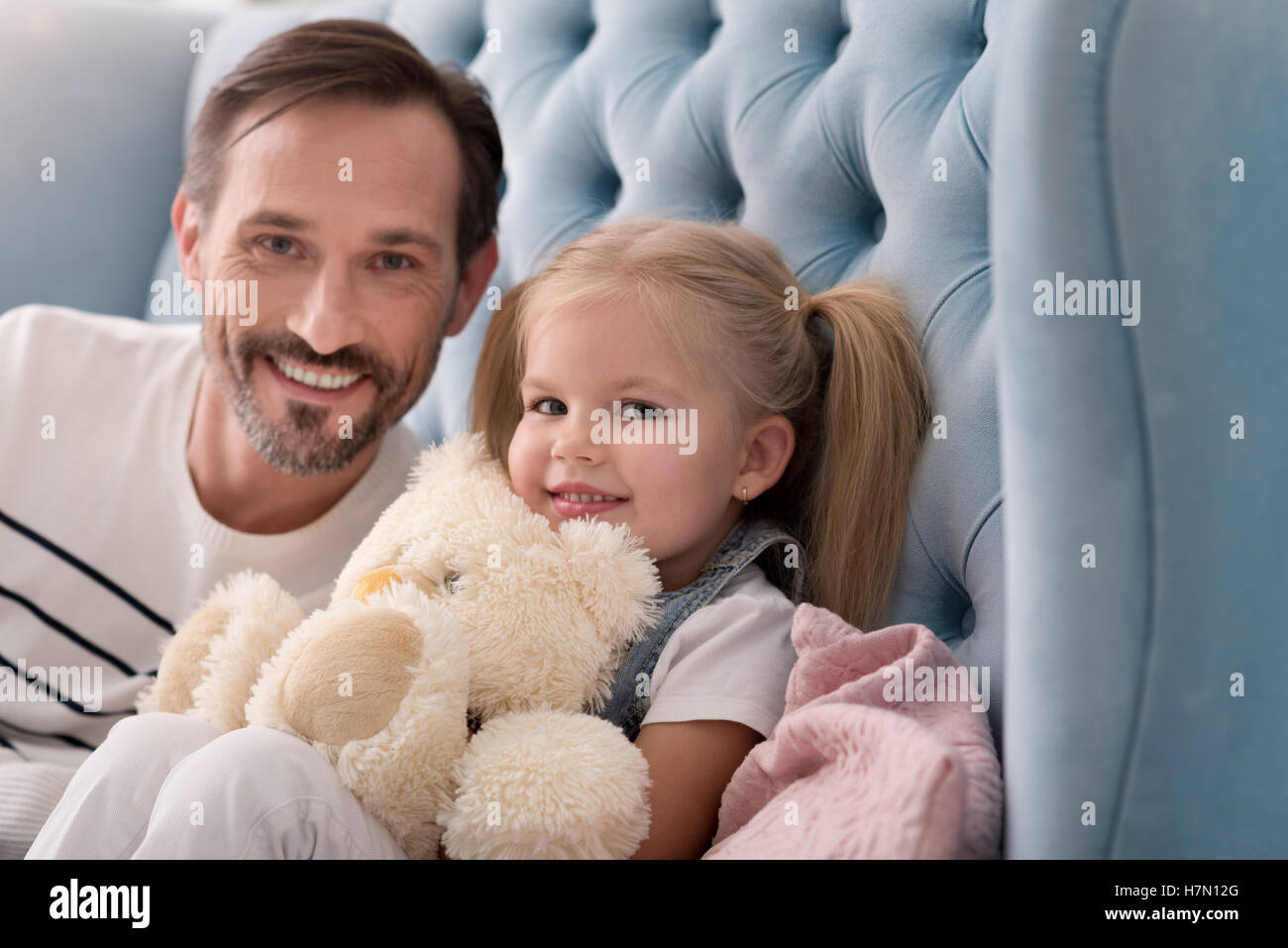 Cheerful happy girl sitting with her father Stock Photo