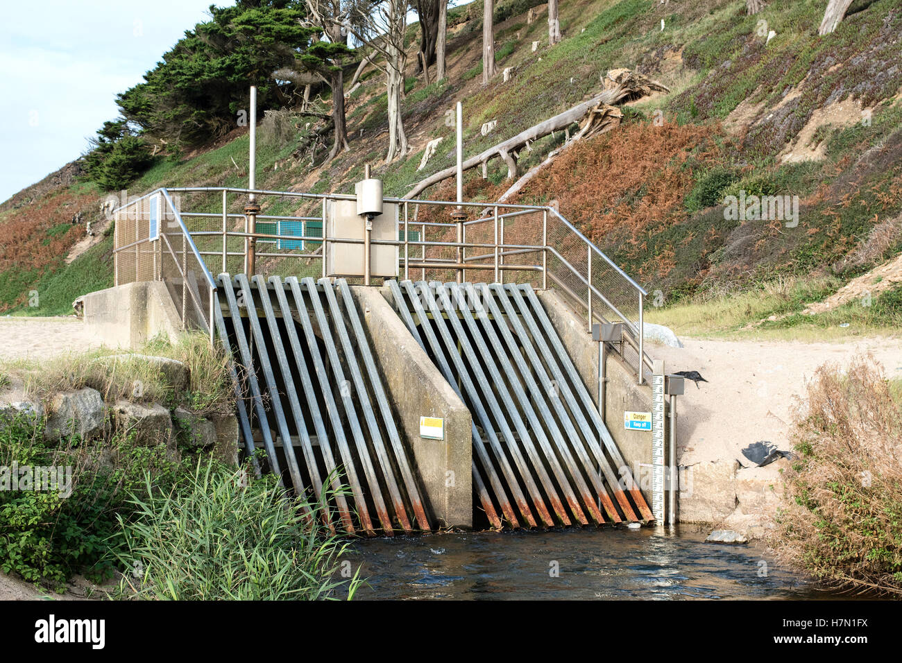 Sluice gates at Loe Bar beach river overflow drainage channel near Helston in Cornwall, UK Stock Photo