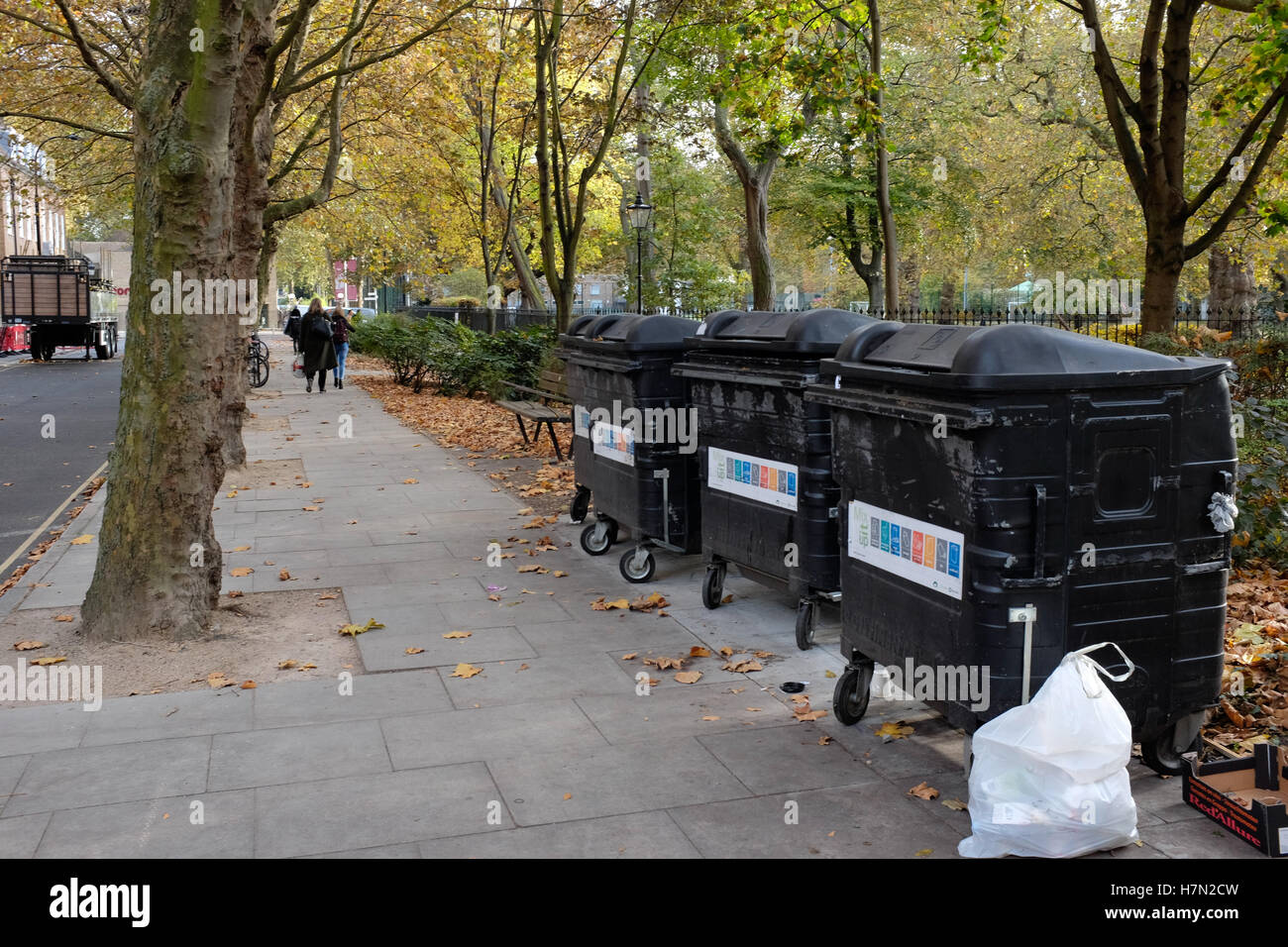 Three large wheelie bins with bag of rubbish Stock Photo Alamy