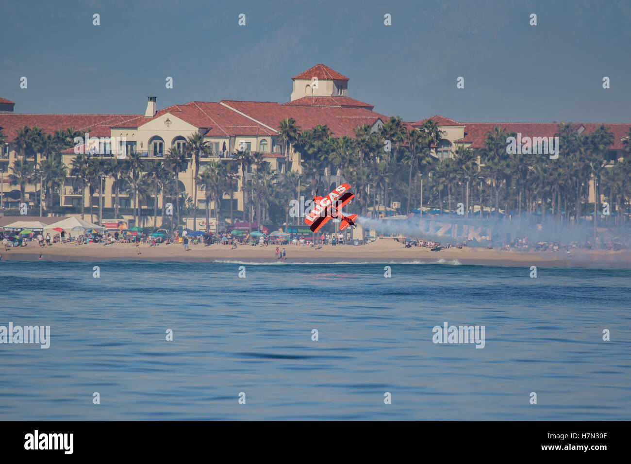 Huntington Beach air show Lucas oil aerobatics stunt plane flies along