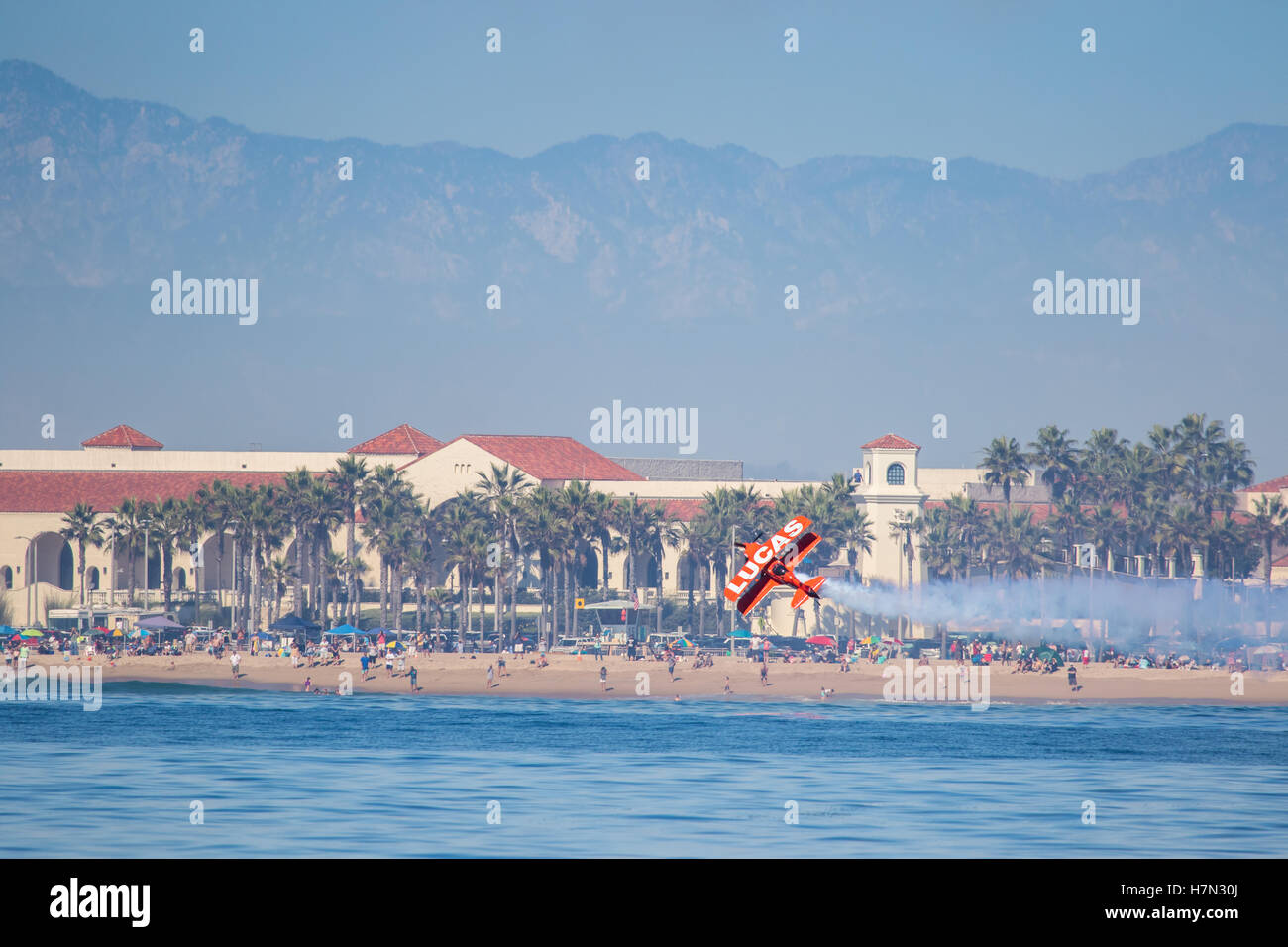 Huntington Beach air show Lucas oil aerobatics stunt plane flies along