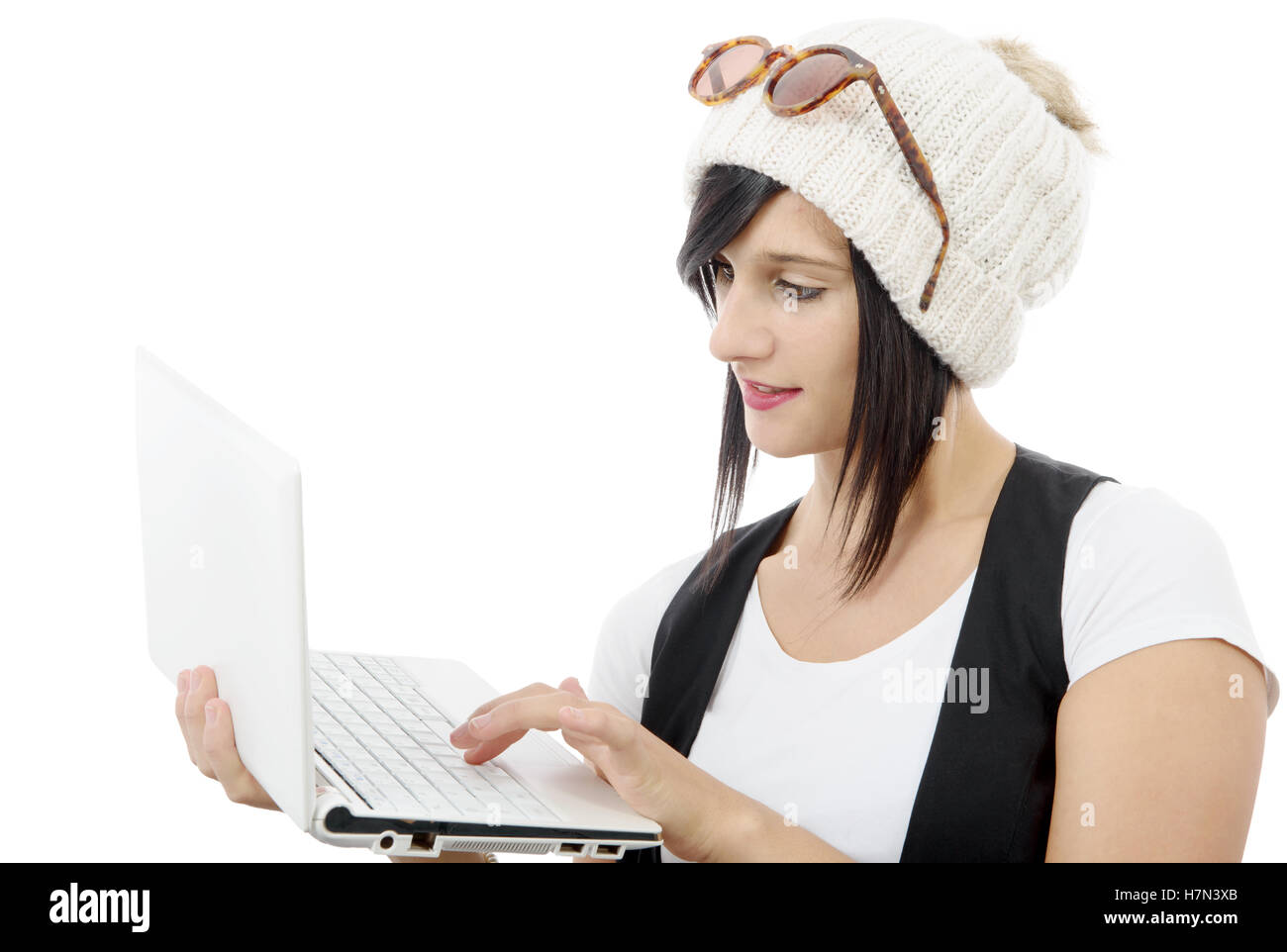 young brunette girl with a laptop isolated on white background Stock ...