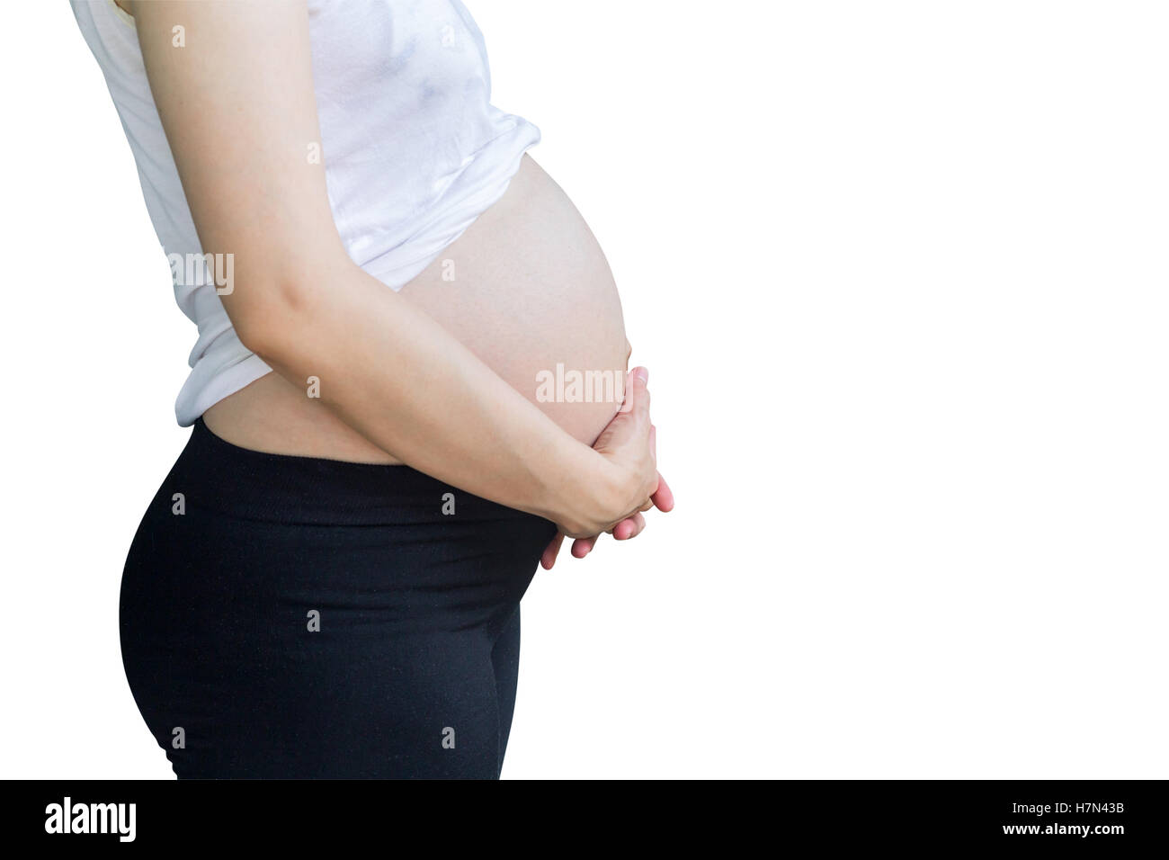 pregnant woman holding tummy on isolated white with clipping path. Stock Photo