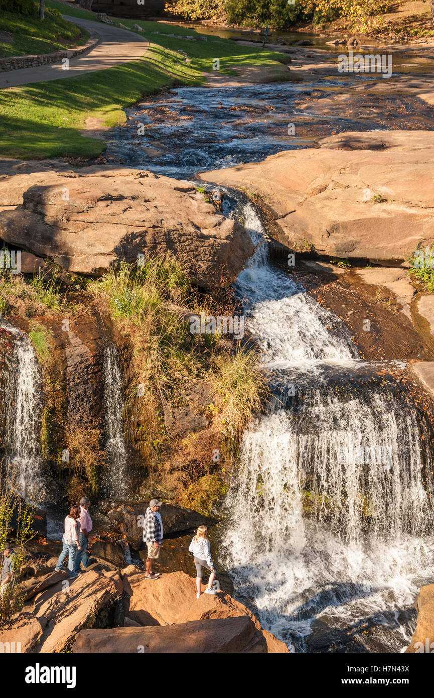 People enjoying the view of Falls Park on the Reedy in downtown Greenville, South Carolina, USA. Stock Photo
