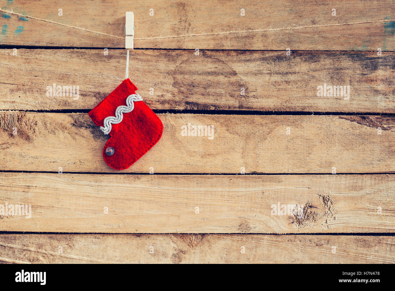 red sock for Santa gifts hanging over rustic wooden background. christmas stocking Stock Photo