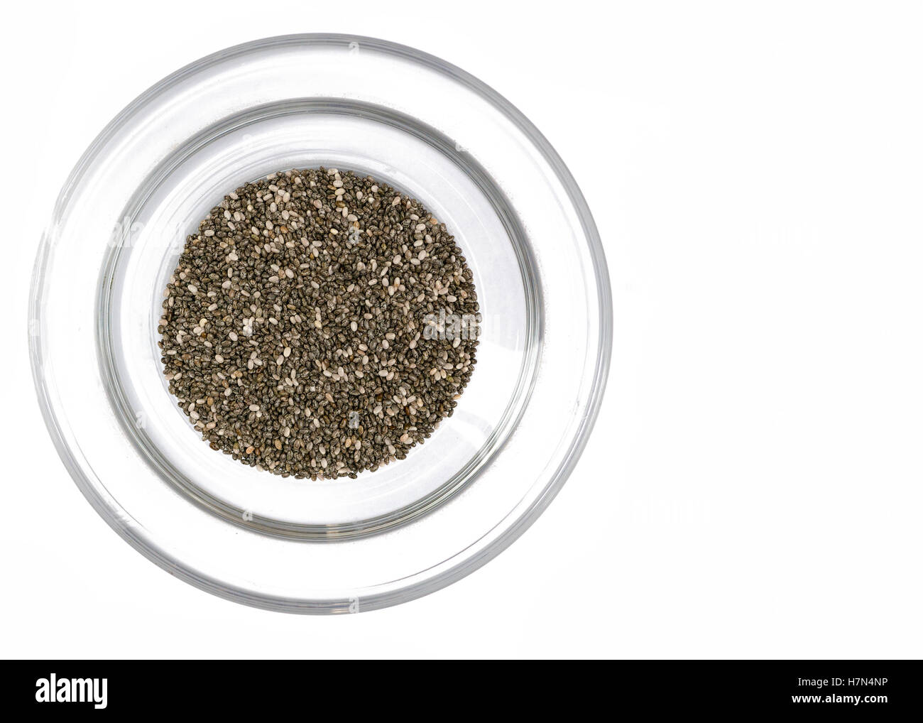 Over head shot of chia seeds in a glass bowl on a white  background, room for texts Stock Photo