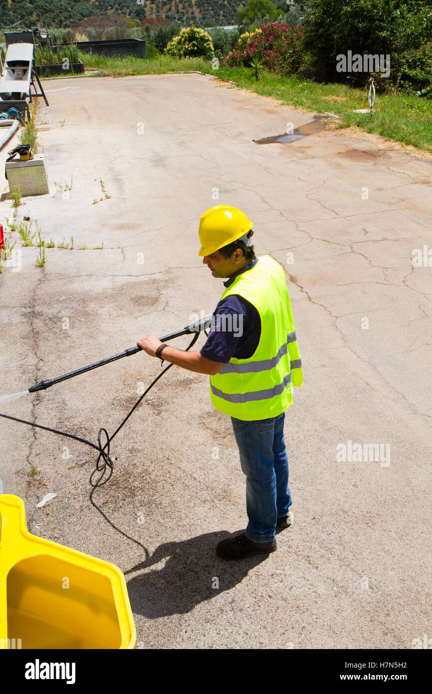 worker cleaning the floor with a pressure washer Stock Photo - Alamy