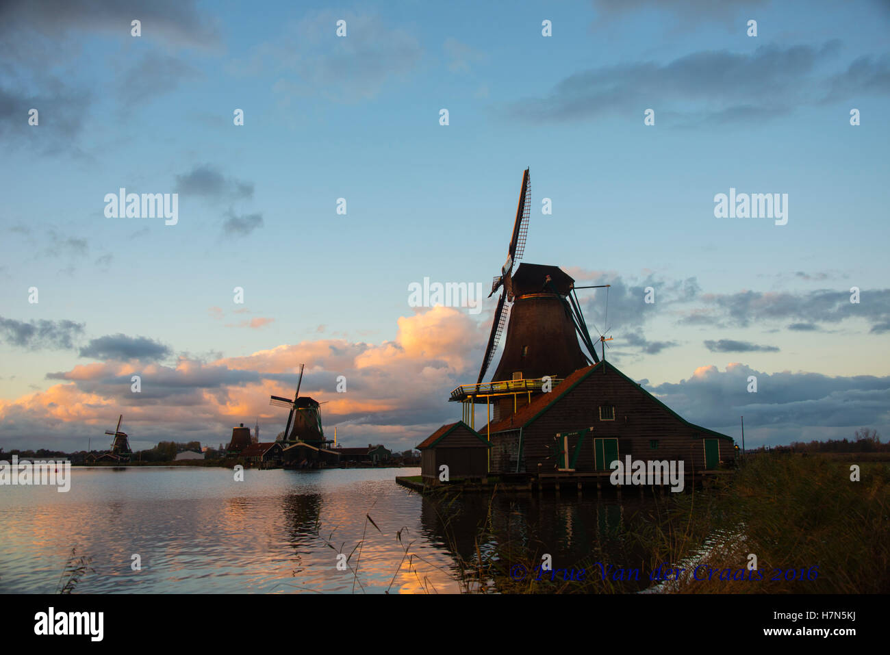 Dutch windmill Zaandam Holland on the weir canal at sunset and day time
