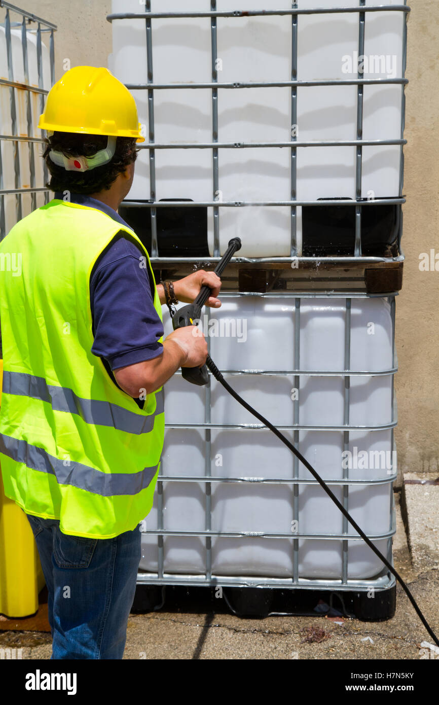 worker cleaning the floor with a pressure washer Stock Photo - Alamy