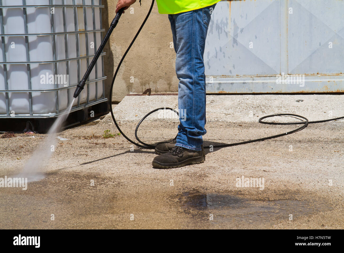 worker cleaning the floor with a pressure washer Stock Photo Alamy